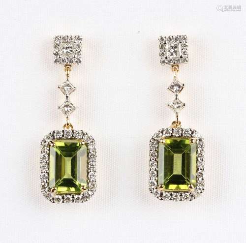 A pair of gold, peridot and diamond pendant earrings, each c...