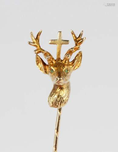 A gold stickpin, the finial designed as a stag's head with a...