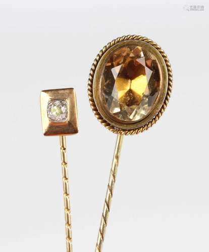 A gold and diamond stickpin, the finial mounted with a cushi...