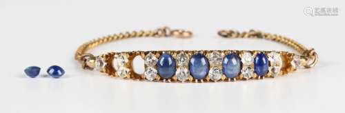 A gold, cabochon sapphire, blue and colourless gem set brace...