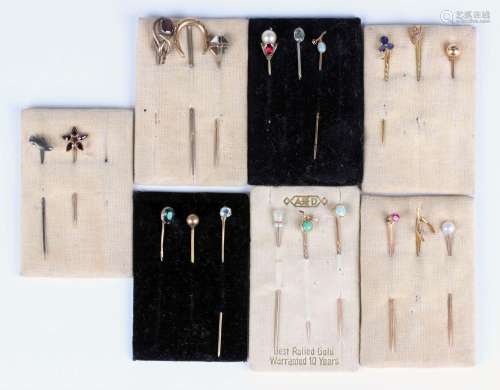 Twenty stickpins, including a gold stickpin, the finial desi...