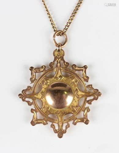 A 9ct gold pendant medallion with a central roundel within a...
