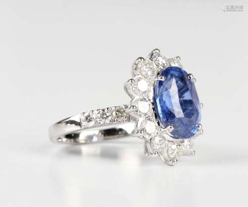 A white gold, sapphire and diamond oval cluster ring, claw s...