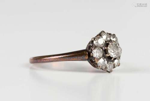A diamond nine stone cluster ring, claw set with the princip...