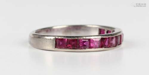 A ruby half eternity ring, mounted with a row of square cut ...