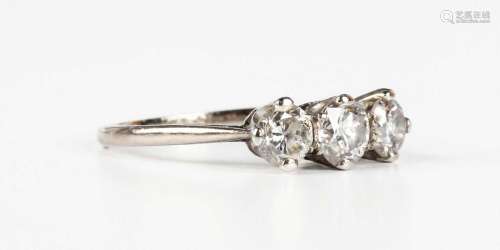A white gold and diamond three stone ring, claw set with a c...