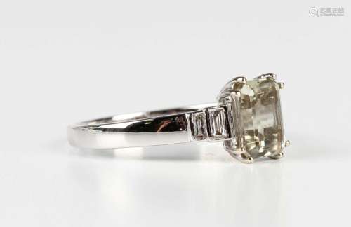An 18ct white gold ring, mounted with a rectangular step cut...