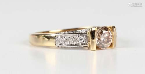 An 18ct gold ring, claw set with the principal circular cut ...