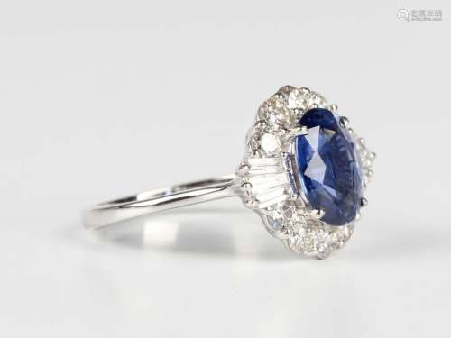 A white gold, sapphire and diamond oval cluster ring, claw s...