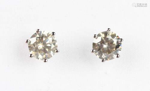 A pair of white gold and diamond single stone earstuds with ...