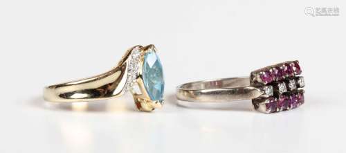 A gold, blue topaz and diamond ring in a crossover design, m...