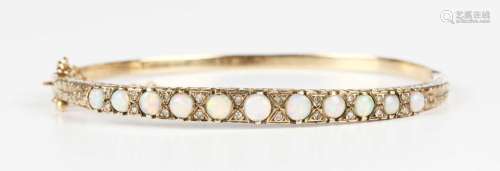 A gold, opal and diamond oval hinged bangle, the front mount...