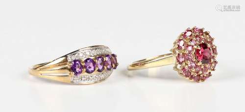 A 9ct gold, amethyst and diamond ring, claw set with a row o...