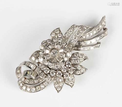 A platinum and diamond brooch, circa 1920, in a scrolling fl...