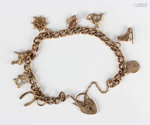 A 9ct gold curblink charm bracelet with a 9ct gold heart sha...