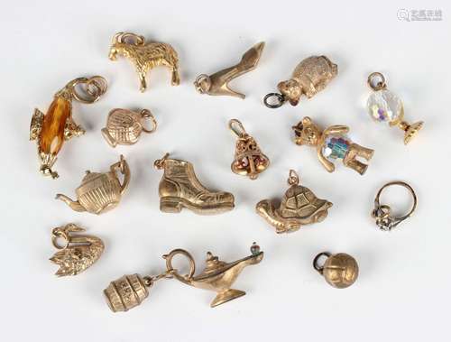 Fifteen 9ct gold charms, including a swan, a teapot, a lady'...