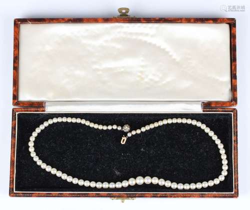 A single row necklace of graduated cultured pearls on a diam...