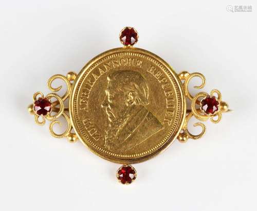 A South Africa gold one pond 1896 in a gold and garnet set b...