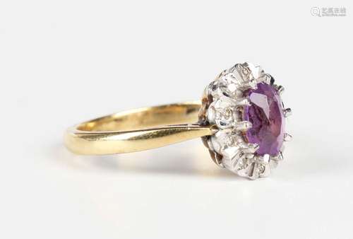 An 18ct gold, amethyst and diamond oval cluster ring, London...