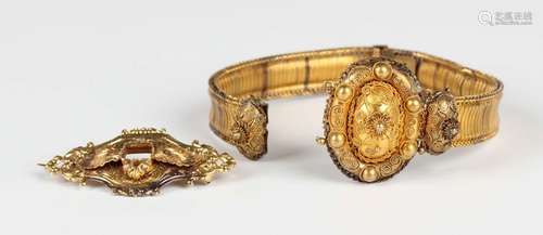 A Victorian gold bracelet, the front with an oval panel appl...