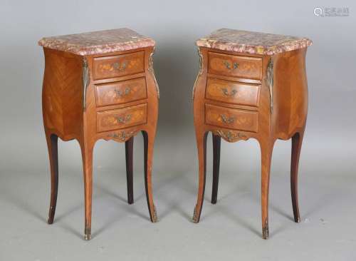 A pair of 20th century French walnut bedside chests of bombé...