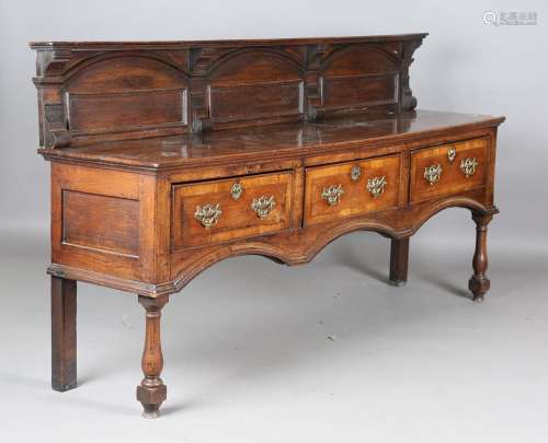 An 18th century provincial oak dresser base with a later car...