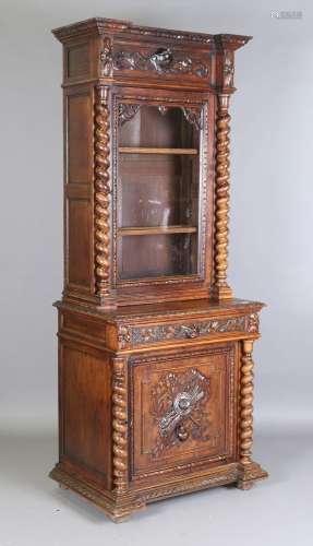 A mid-19th century Baroque Revival oak bookcase cabinet