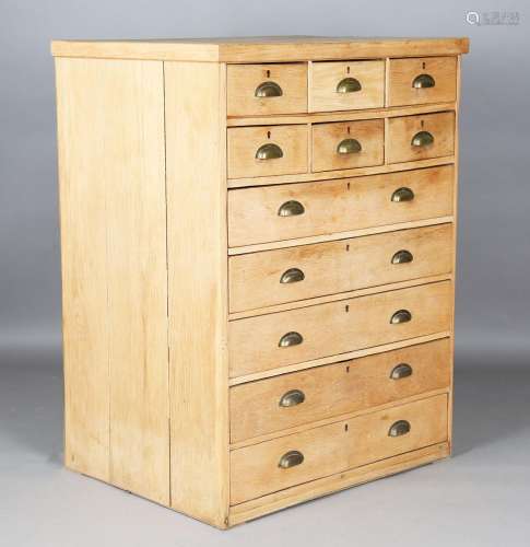 An early 20th century oak bank of eleven drawers