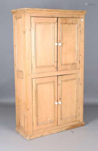 A 19th century stripped pine four-door cupboard