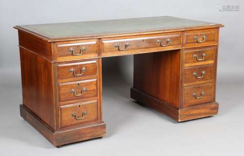 A late Victorian walnut twin pedestal desk