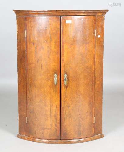 A George I burr walnut hanging bowfront corner cabinet