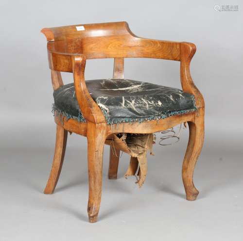 A 19th century Continental walnut tub back open armchair