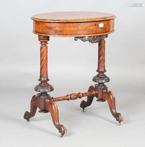 A Victorian walnut oval work table