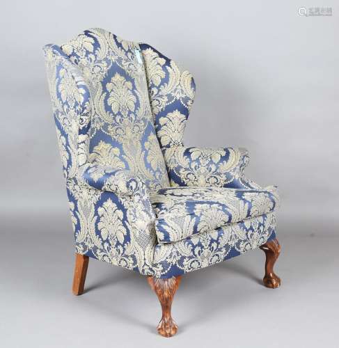 A 20th century George III style wingback armchair