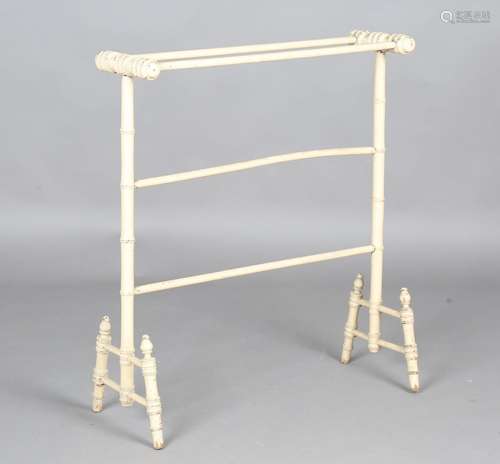 A 19th century cream painted wooden towel rail