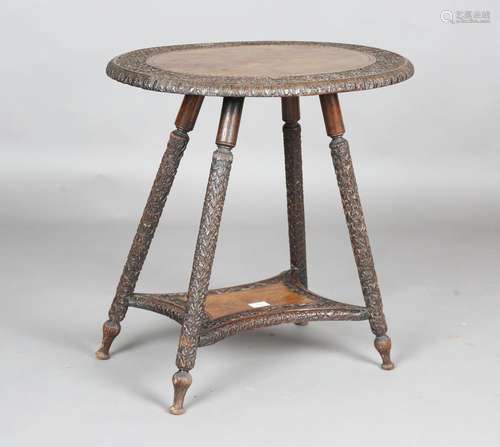 An early 20th century Indian hardwood oval two-tier occasion...