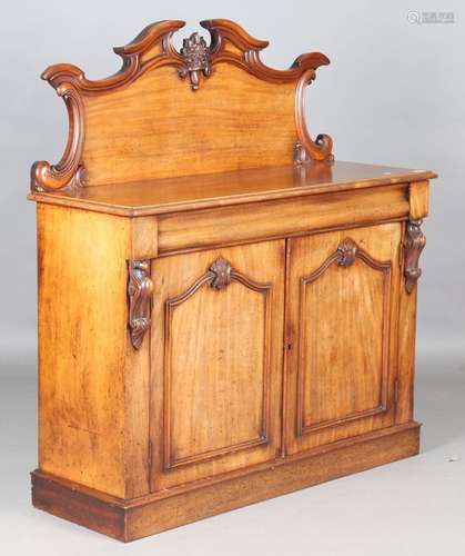 A Victorian mahogany chiffonier with a carved foliate back