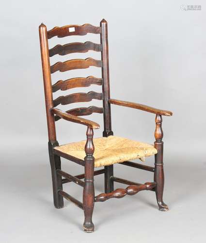 A 19th century provincial ash ladder back nursing chair with...