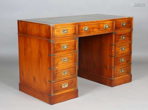 A 20th century yew campaign style twin pedestal desk with ov...