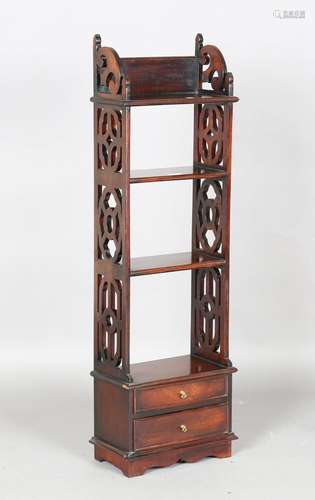 A modern hardwood open bookcase with fretwork sides and two ...