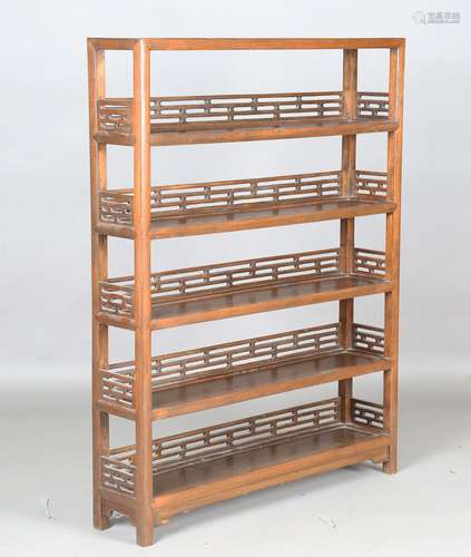 A Chinese stained elm five-tier open bookcase with pierced g...