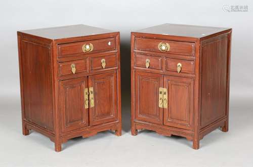 A pair of Chinese stained softwood bedside cabinets