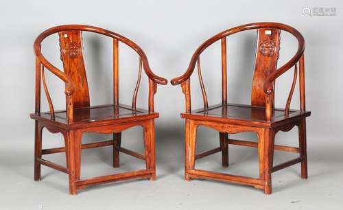 A pair of Chinese stained elm horseshoe back armchairs with ...