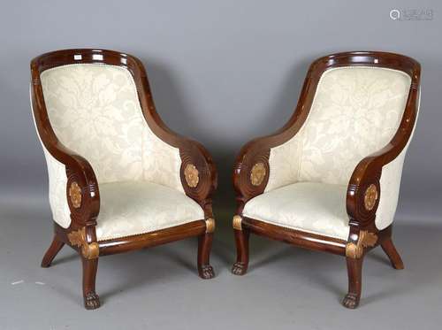 A pair of 20th century Empire style mahogany showframe armch...