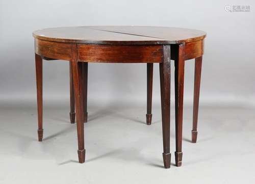 A pair of George III mahogany demi-lune tables