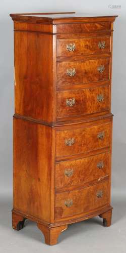 A 20th century reproduction burr walnut bowfront tallboy