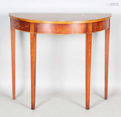 A late 20th century reproduction mahogany demi-lune table wi...