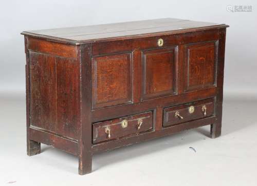 An 18th century oak mule chest with triple panel front