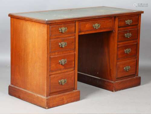 An Edwardian walnut twin pedestal desk with a gilt-tooled gr...