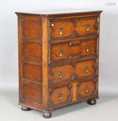 A George V Carolean Revival oak chest of four long drawers